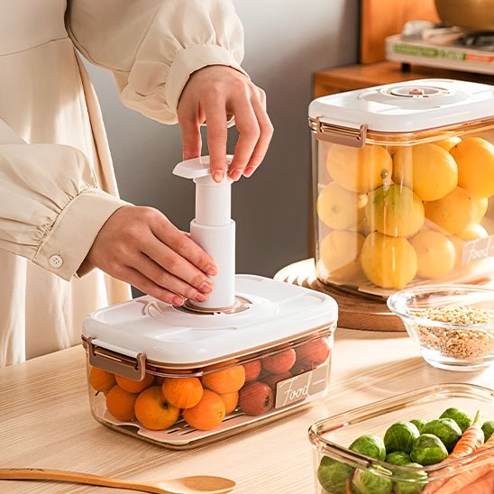 Femme qui utilise la pompe sur la boite de conservation alimentaire 